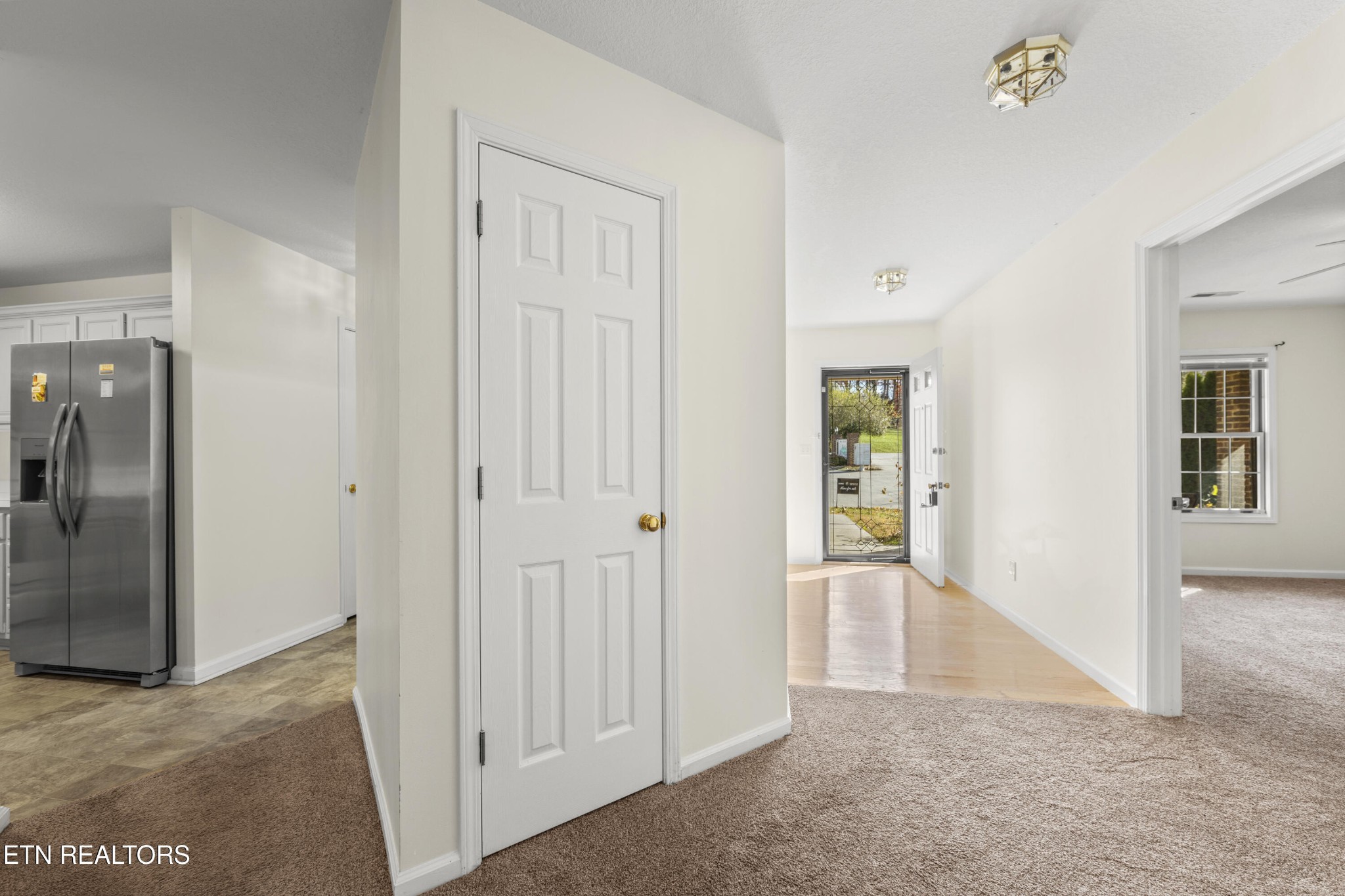 1218 Ernest McMahan Road Sevierville, TN 37862 - Photo 9 of 40 an empty room with windows and entrance to other room