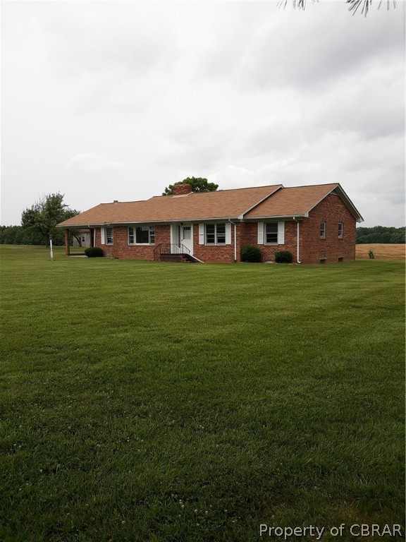 1498 Sharps Road Warsaw, VA 22572 - Photo 2 of 21 a view of a big room with a big yard and large trees