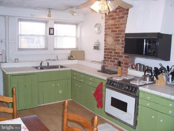 53 Kinship Road Dundalk, MD 21222 - Photo 8 of 17 a kitchen with a sink stove and microwave