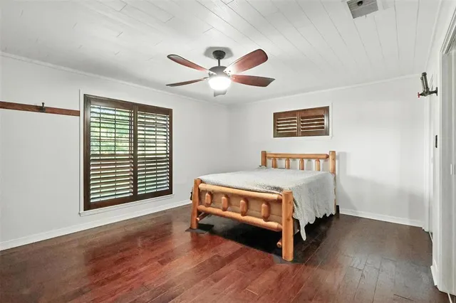 a spacious bedroom with a bed and a window