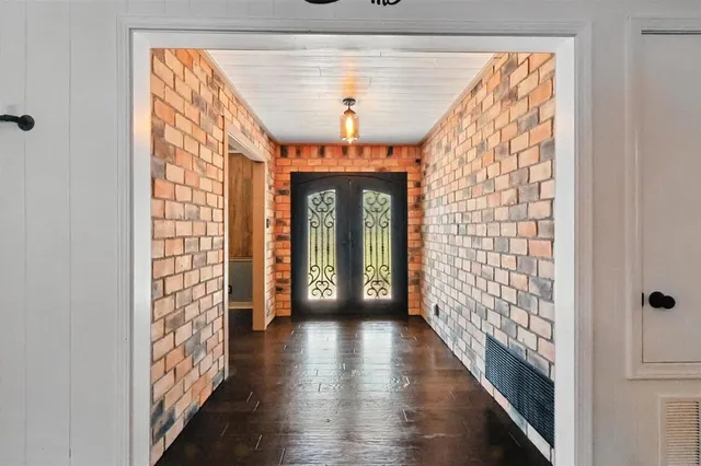 a view of entryway with wooden floor and chandelier