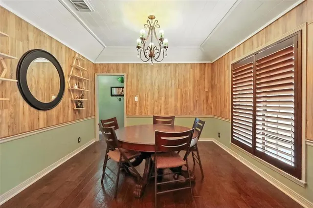 a view of a dining room with furniture and chandelier