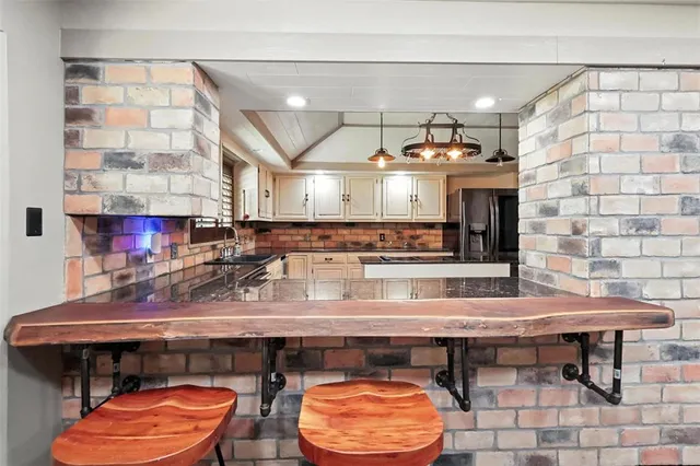 a kitchen with a wooden table and chairs