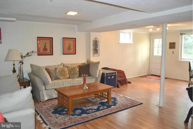 a living room with furniture and a wooden floor
