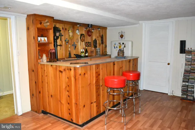 a view of a room with wooden floor and furniture