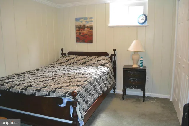 a bed sitting in a bedroom next to a window