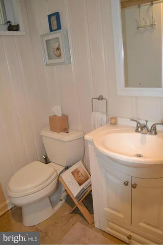 a white toilet sitting next to a bathroom sink
