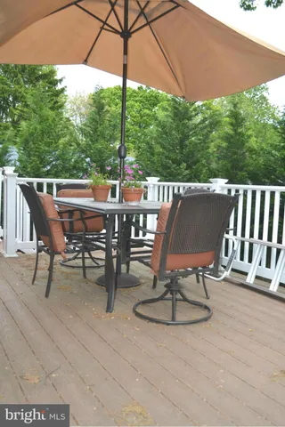 a view of a patio with table and chairs under an umbrella