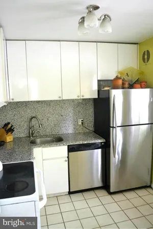 a kitchen with a refrigerator a stove and a microwave
