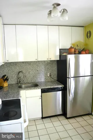a kitchen with a refrigerator a stove and a microwave