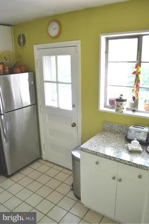 a bathroom with a granite countertop sink and a window