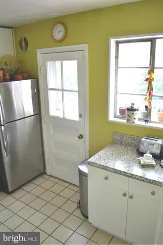 a bathroom with a granite countertop sink and a window