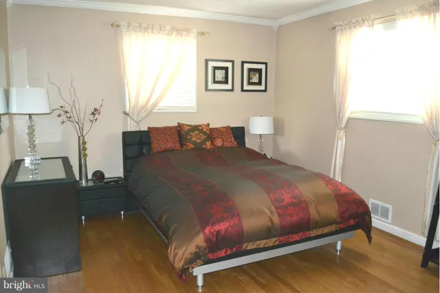 a bedroom with a bed and a night stand