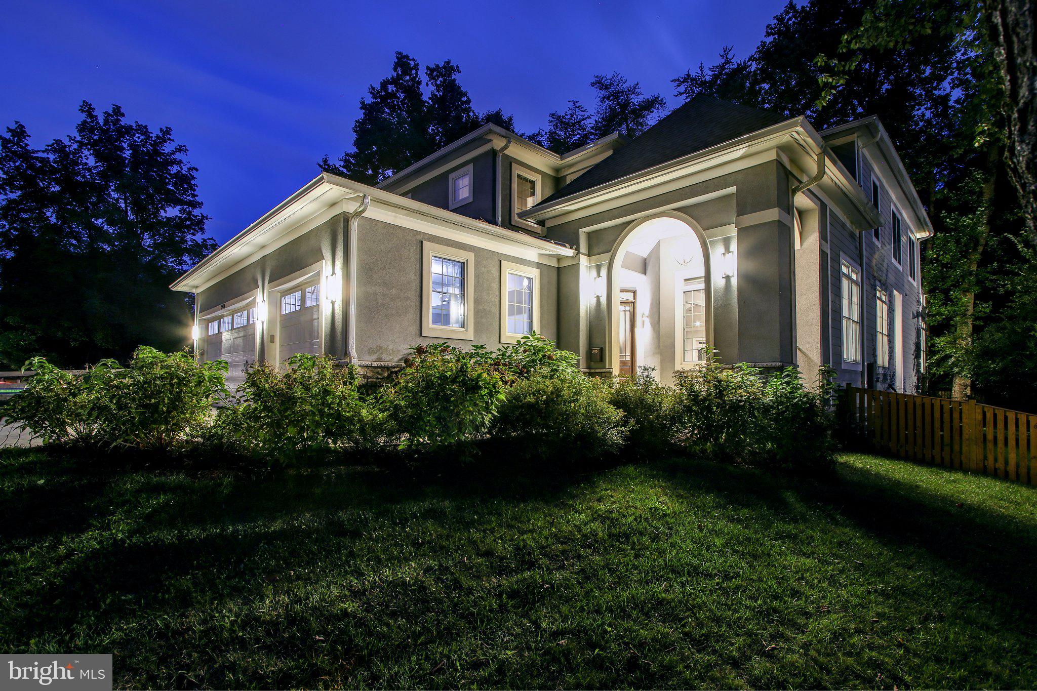 Elegant home illuminated at dusk.