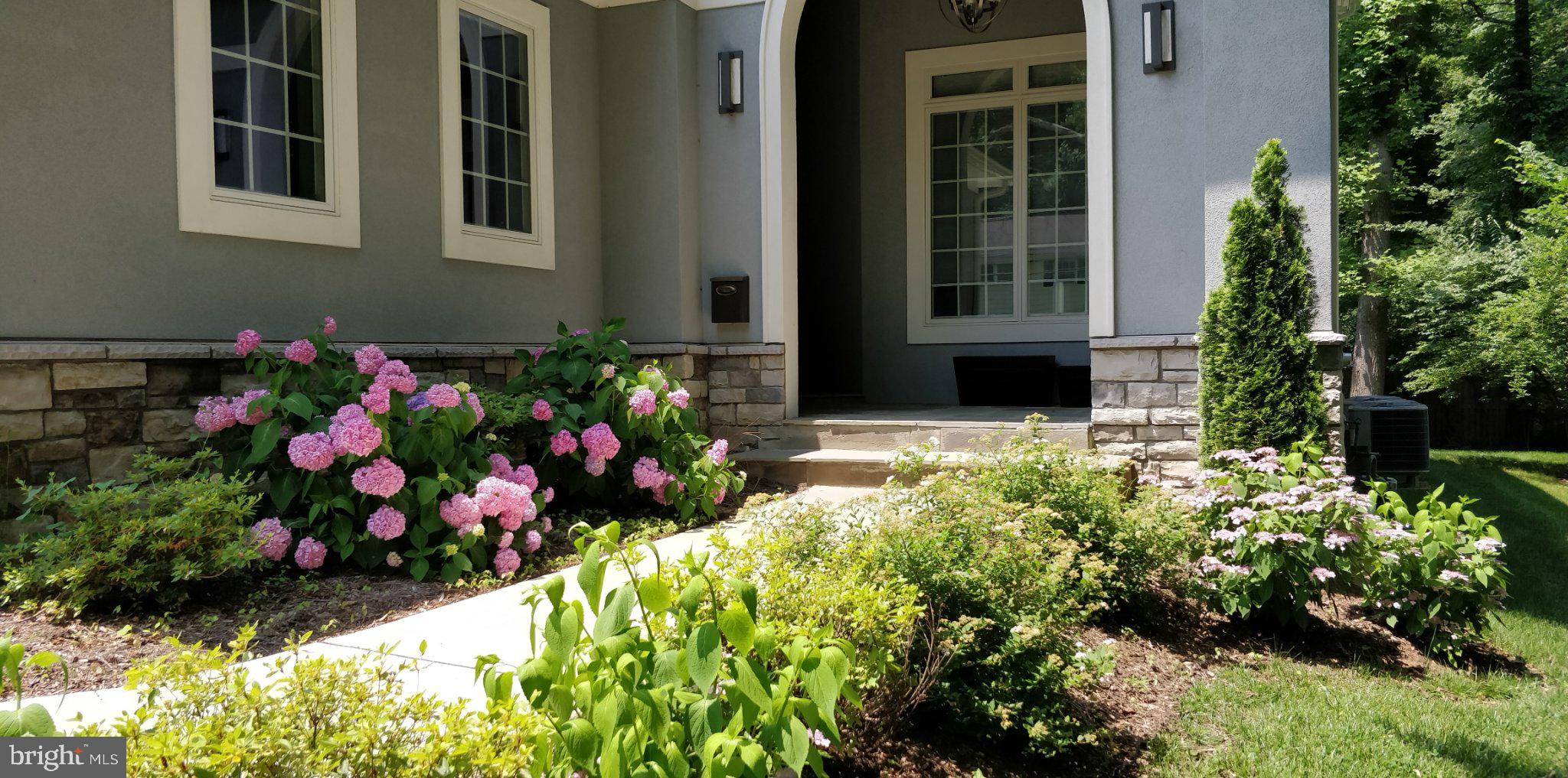 9814 Fernwood Road Bethesda, MD 20817 - Photo 3 of 31 Charming entrance with vibrant blooms.
