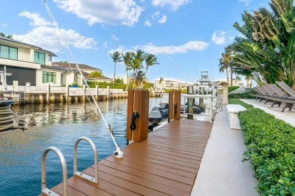 a view of a balcony with dining table and chairs with wooden floor
