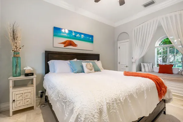 a bedroom with a bed and a window