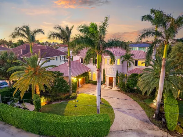 a view of a house with a swimming pool and sitting area