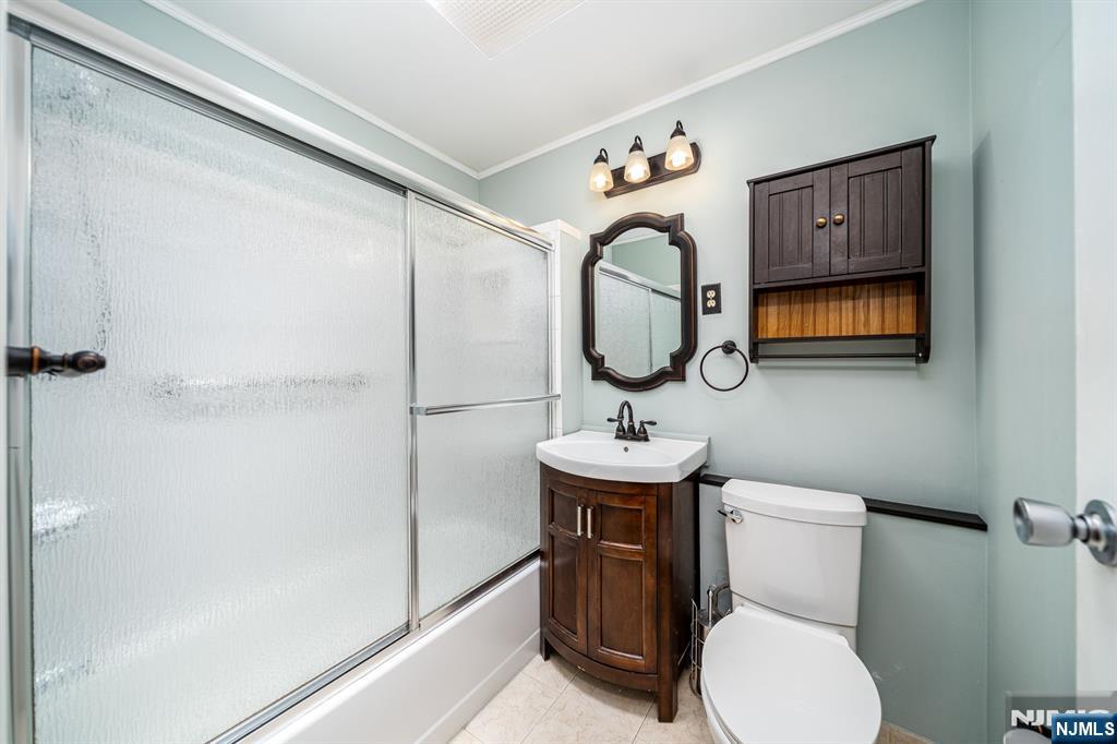 82 Hackensack Street, Unit 3 Wood-Ridge, NJ 07075 - Photo 16 of 19 a bathroom with a toilet sink and mirror