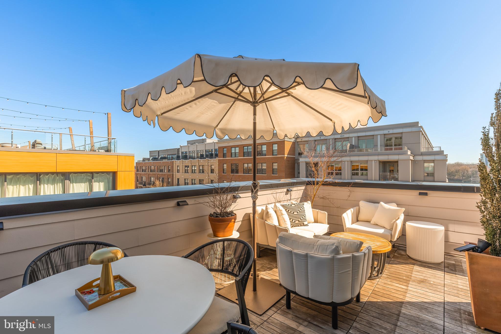 a balcony with table and chairs
