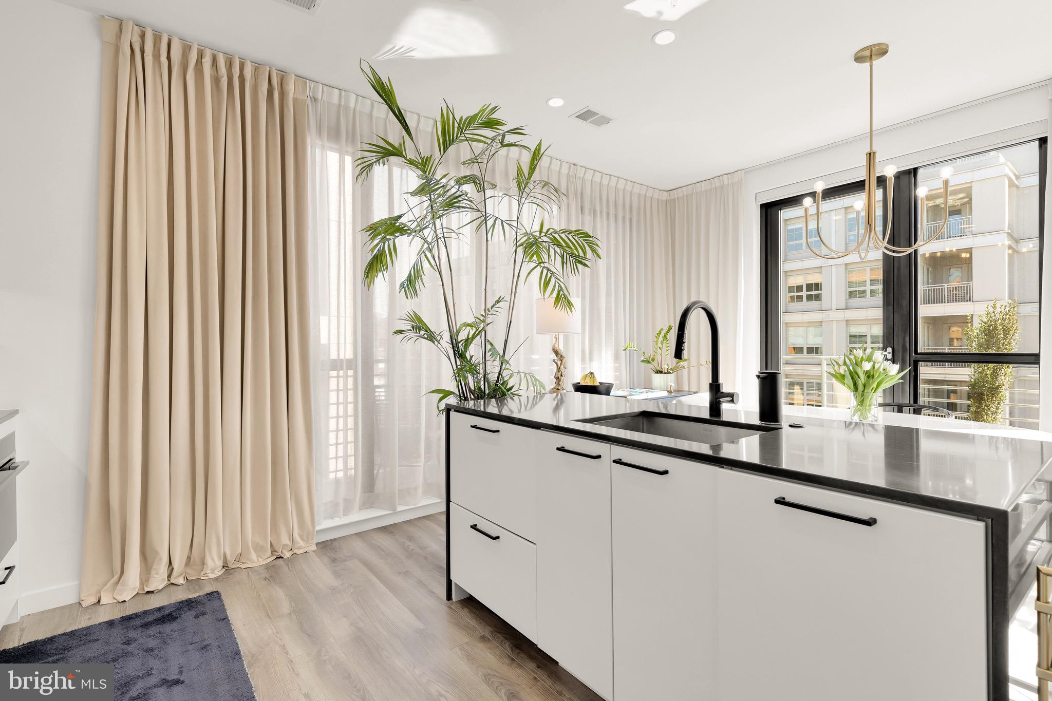 1500 Harry Thomas Way Northeast, Unit 501 Washington, DC 20002 - Photo 12 of 44 a kitchen with white cabinets and a large window