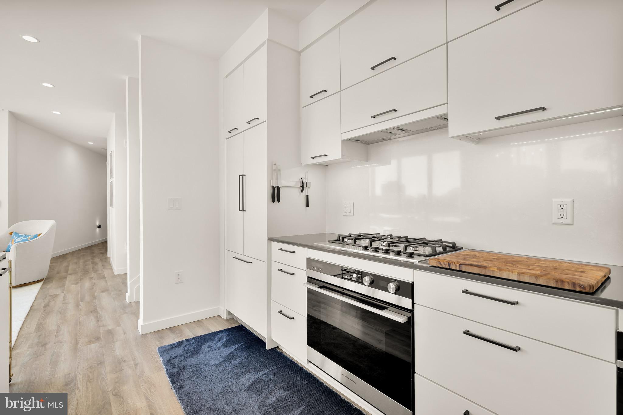 1500 Harry Thomas Way Northeast, Unit 501 Washington, DC 20002 - Photo 14 of 44 a kitchen with white cabinets and a stove