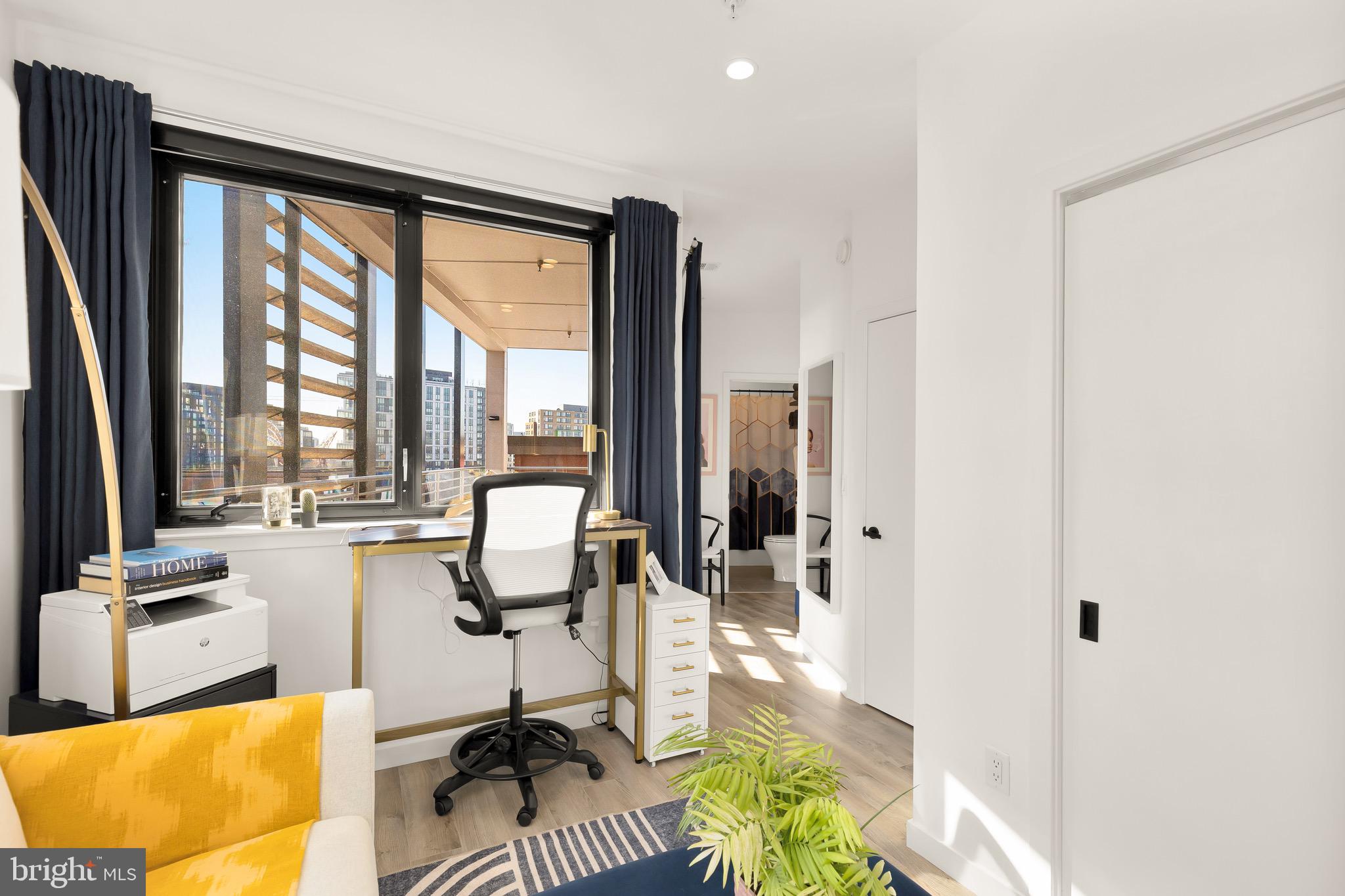 1500 Harry Thomas Way Northeast, Unit 501 Washington, DC 20002 - Photo 20 of 44 a view of a living room with furniture and floor to ceiling window