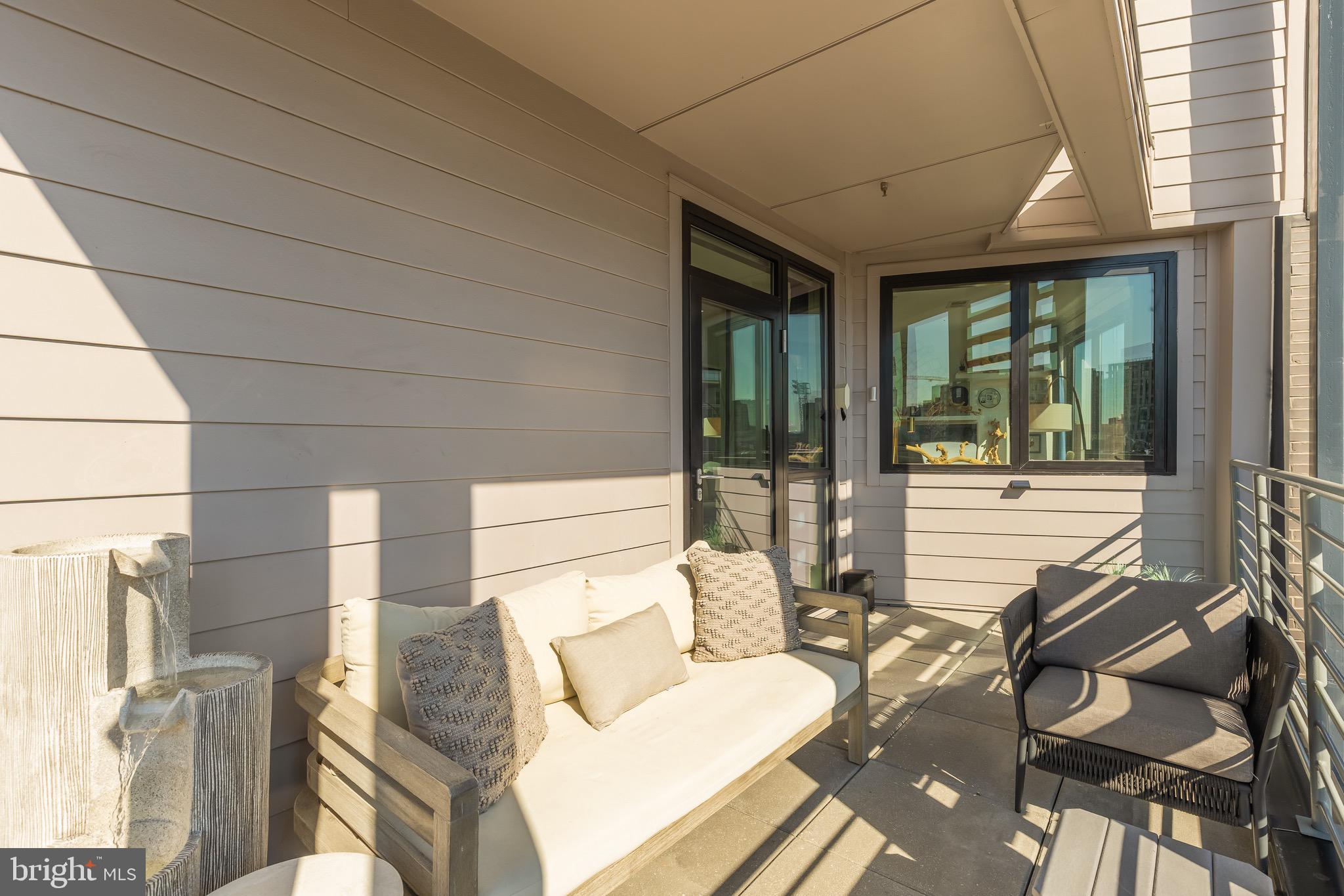 1500 Harry Thomas Way Northeast, Unit 501 Washington, DC 20002 - Photo 24 of 44 a view of a patio with dining table and chairs with wooden floor and fence