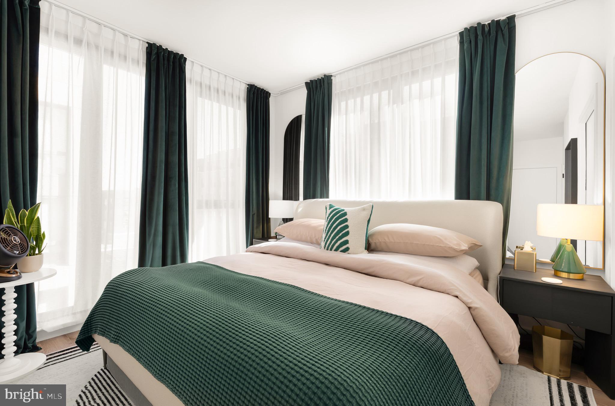 1500 Harry Thomas Way Northeast, Unit 501 Washington, DC 20002 - Photo 26 of 44 a bedroom with a bed wooden floor and a large window