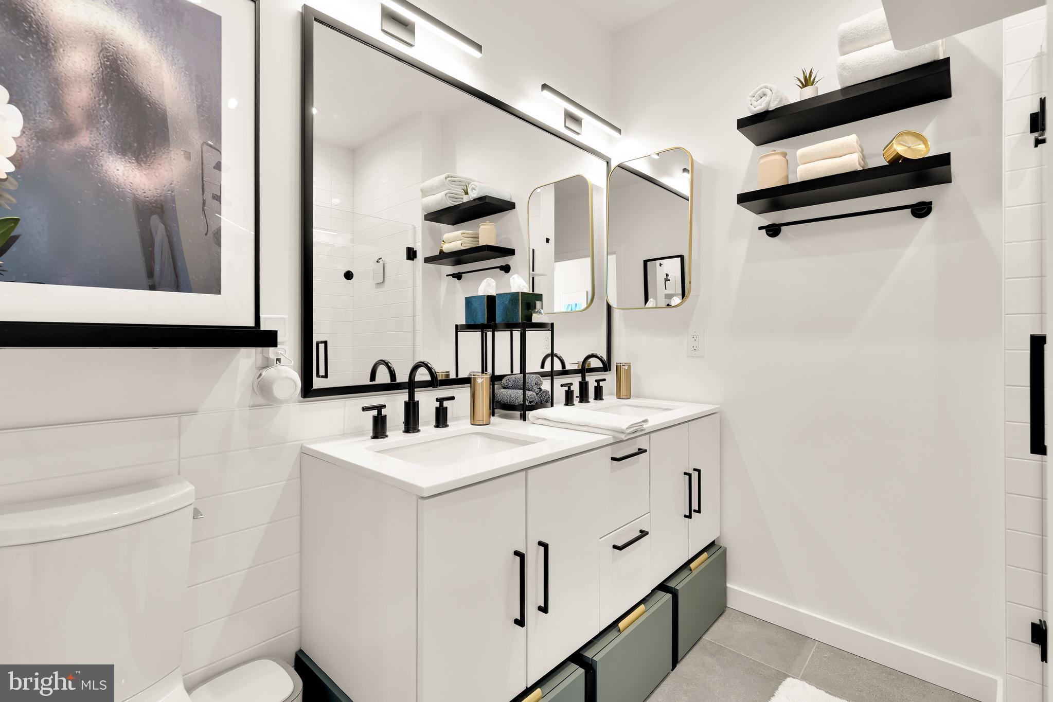 1500 Harry Thomas Way Northeast, Unit 501 Washington, DC 20002 - Photo 29 of 44 a bathroom with a sink a toilet and a mirror