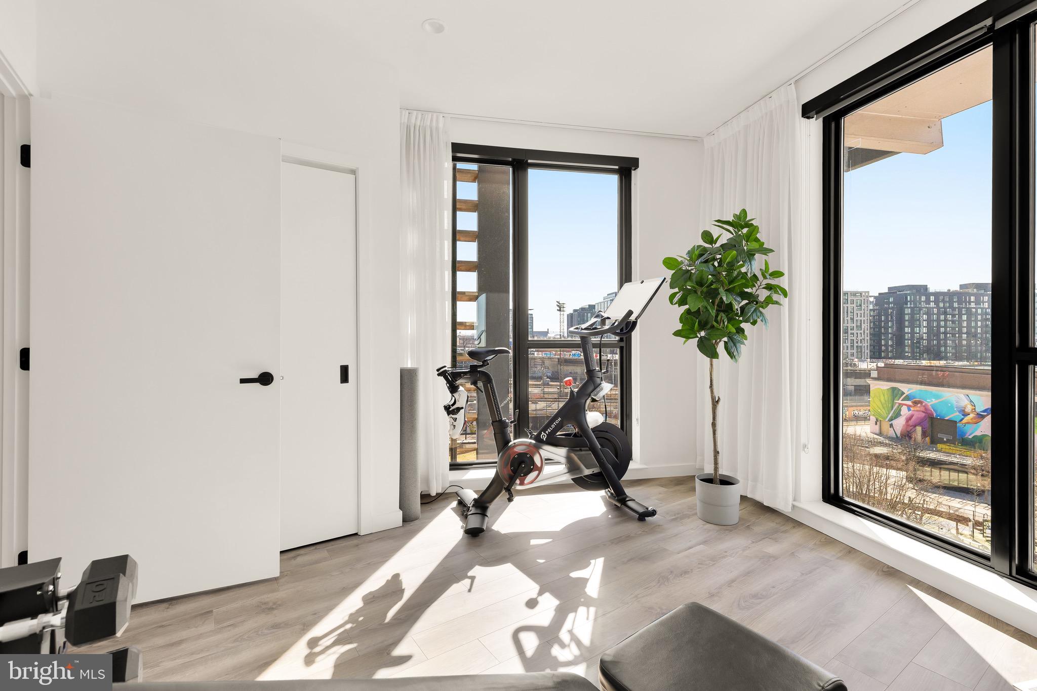 1500 Harry Thomas Way Northeast, Unit 501 Washington, DC 20002 - Photo 31 of 44 a view of a room with gym equipment and floor to ceiling window