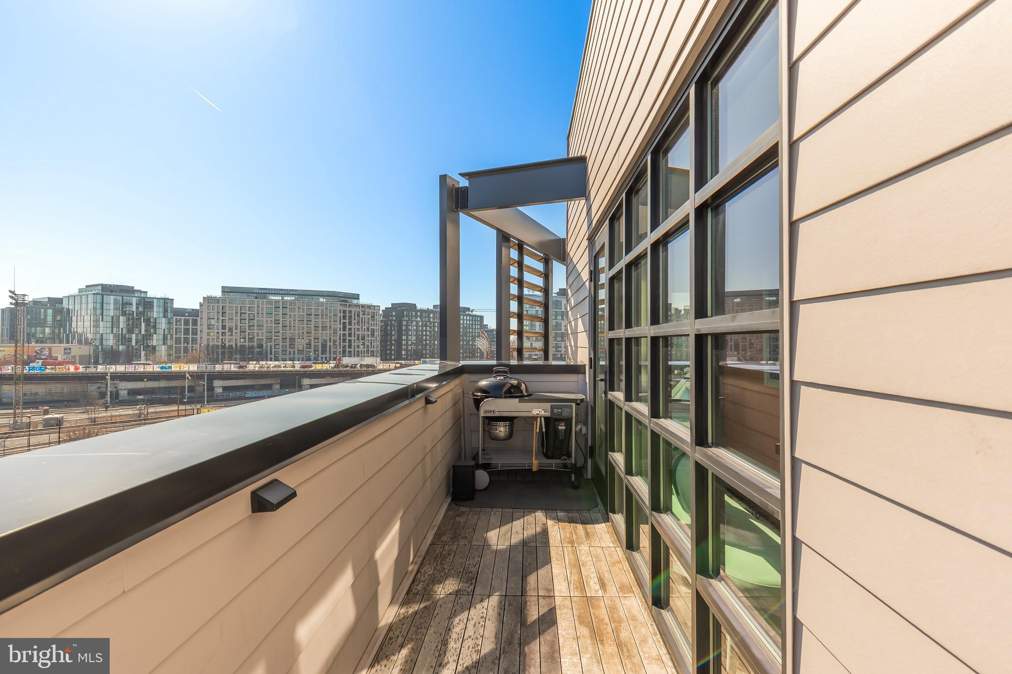1500 Harry Thomas Way Northeast, Unit 501 Washington, DC 20002 - Photo 39 of 44 a view of a balcony with furniture and city view