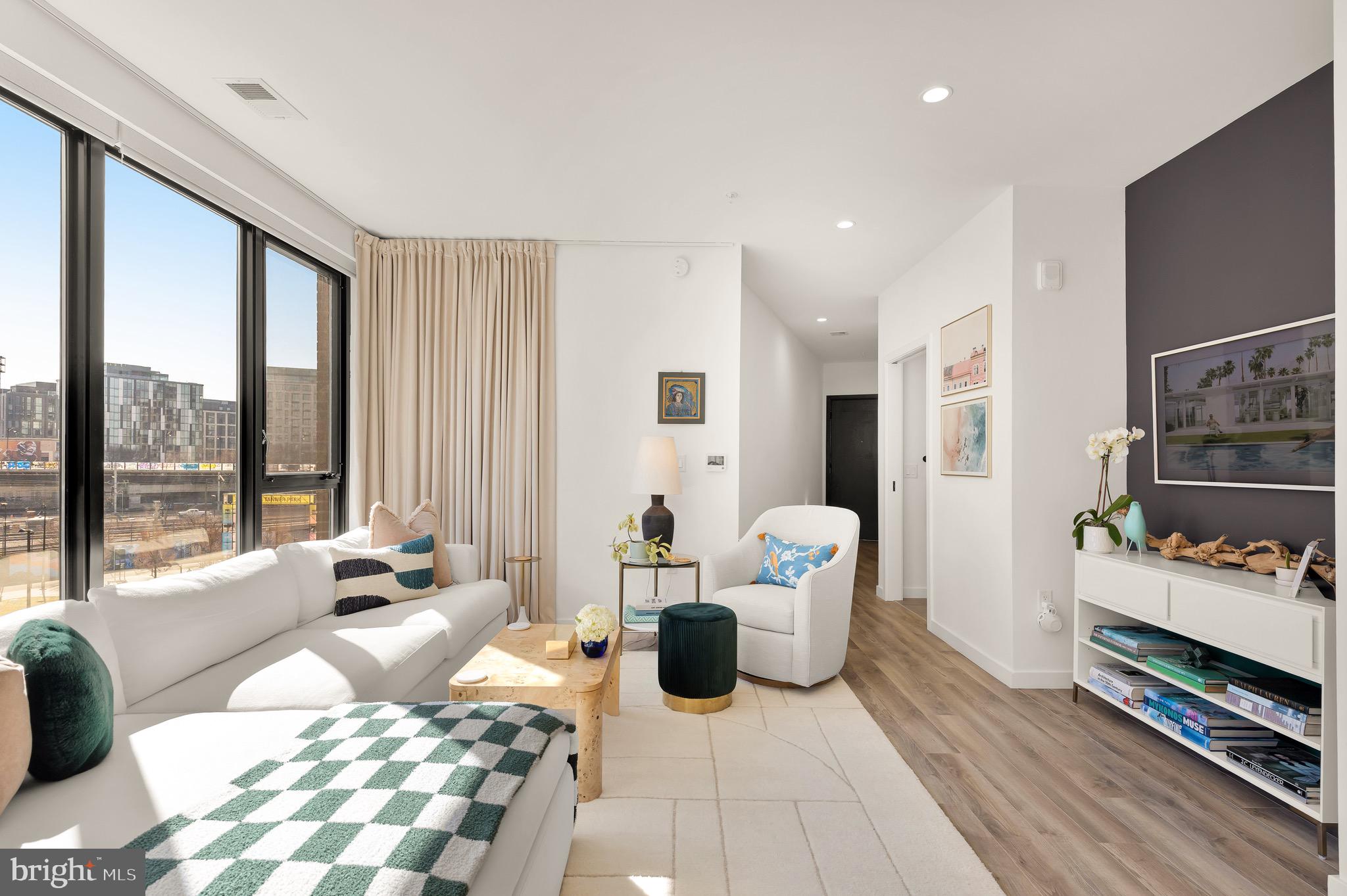 1500 Harry Thomas Way Northeast, Unit 501 Washington, DC 20002 - Photo 5 of 44 a bedroom with furniture and large windows