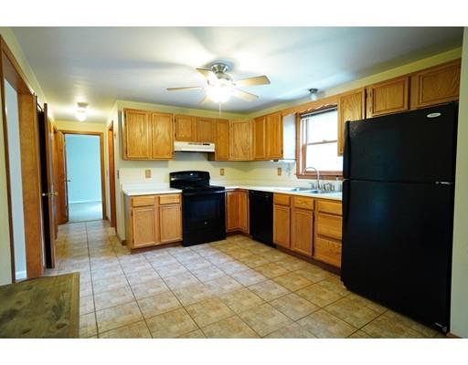 115 Fitzgerald Road Charlton, MA 01507 - Photo 6 of 24 a kitchen with stainless steel appliances granite countertop a refrigerator a sink a stove with cabinets