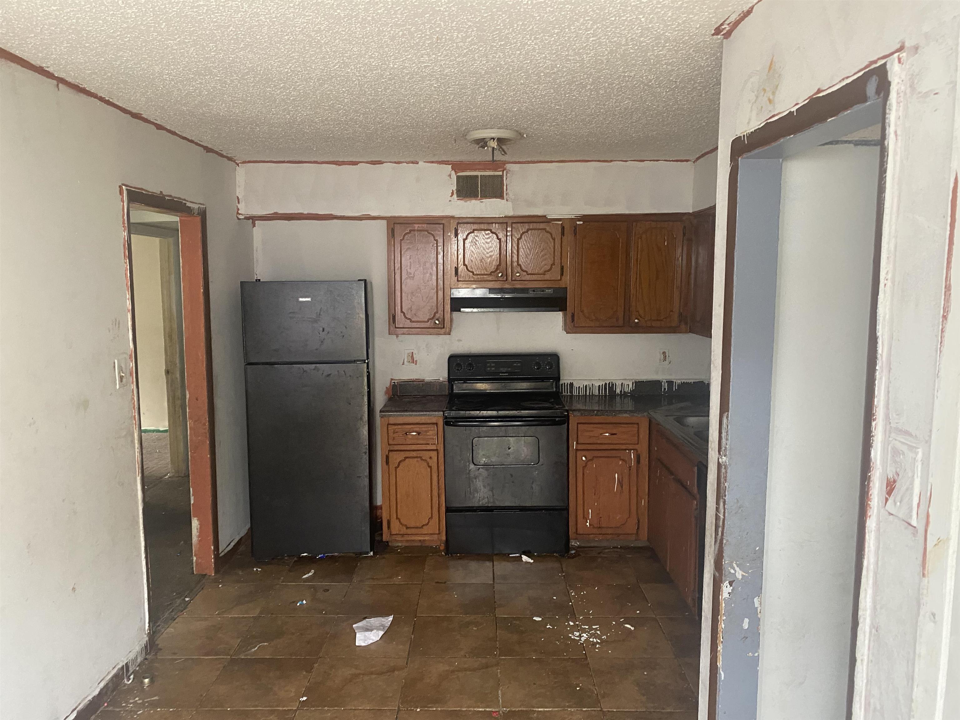4795 Allrand Road Memphis, TN 38118 - Photo 5 of 21 a kitchen with a refrigerator and a sink