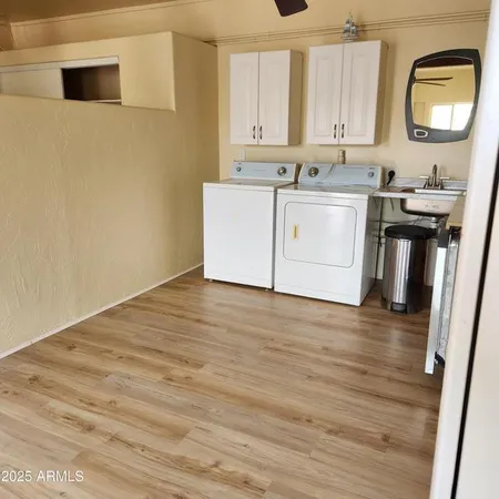 a view of a kitchen with a sink and a wooden floor