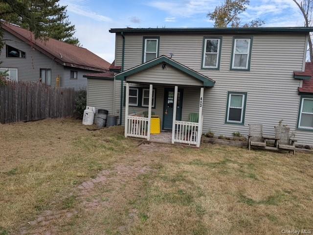 a view of a house with a yard and sitting area
