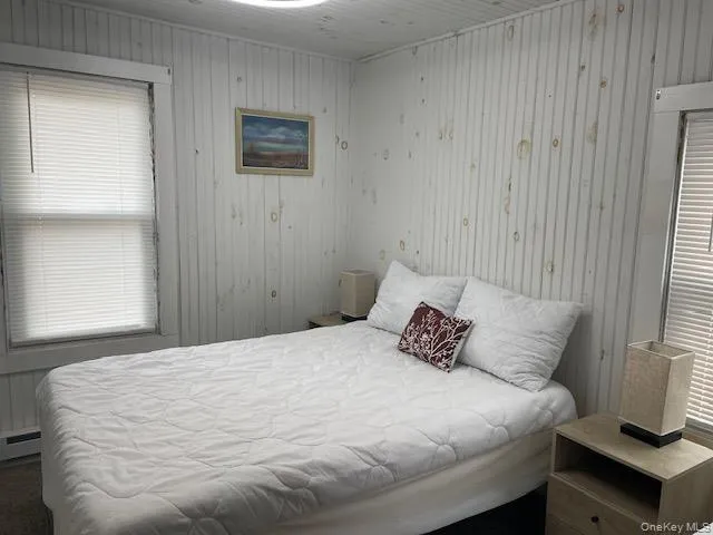 a bedroom with a bed and a chair