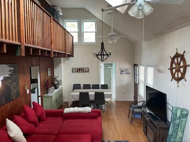 a view of a livingroom with furniture and a flat screen tv