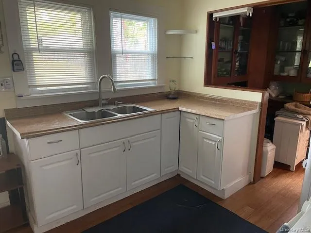 a kitchen with sink cabinets and a window