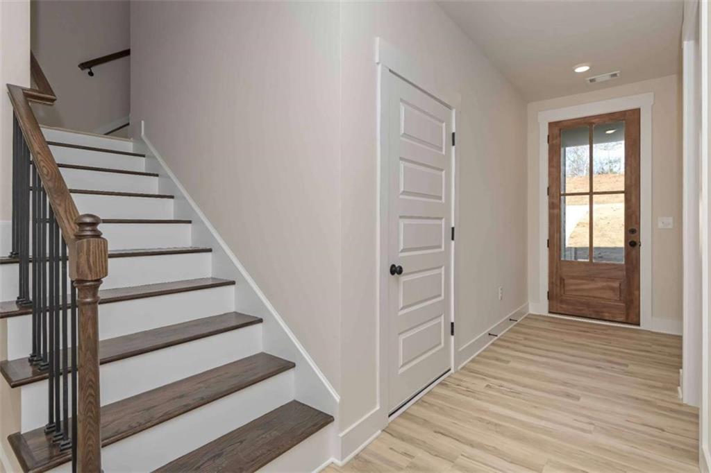96 Rosemary Way Buchanan, GA 30113 - Photo 11 of 31 a view of a hallway with wooden floor and entryway