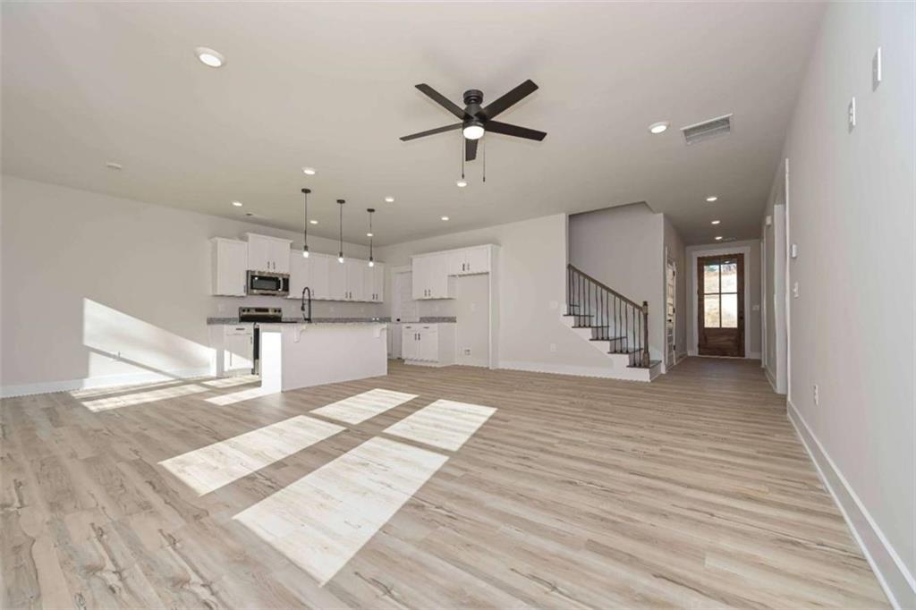 96 Rosemary Way Buchanan, GA 30113 - Photo 13 of 31 a view of kitchen with cabinets and wooden floor