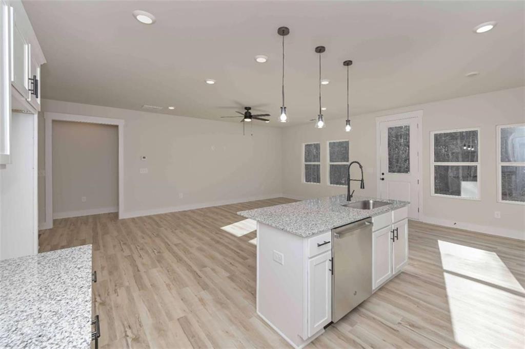 96 Rosemary Way Buchanan, GA 30113 - Photo 20 of 31 a kitchen with a sink stove and wooden floor