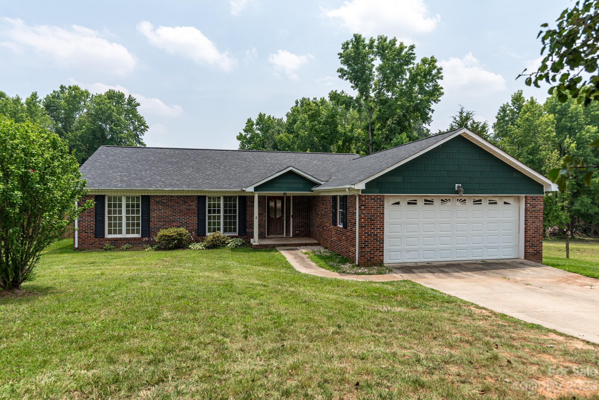 a front view of a house with yard and garage