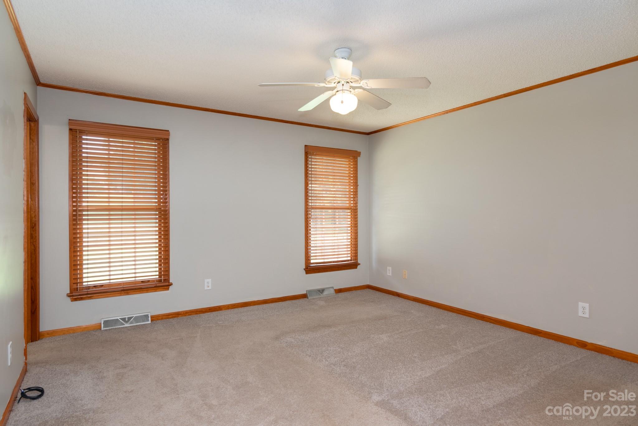920 Bethel Church Road Lincolnton, NC 28092 - Photo 14 of 27 an empty room with windows and chandelier fan