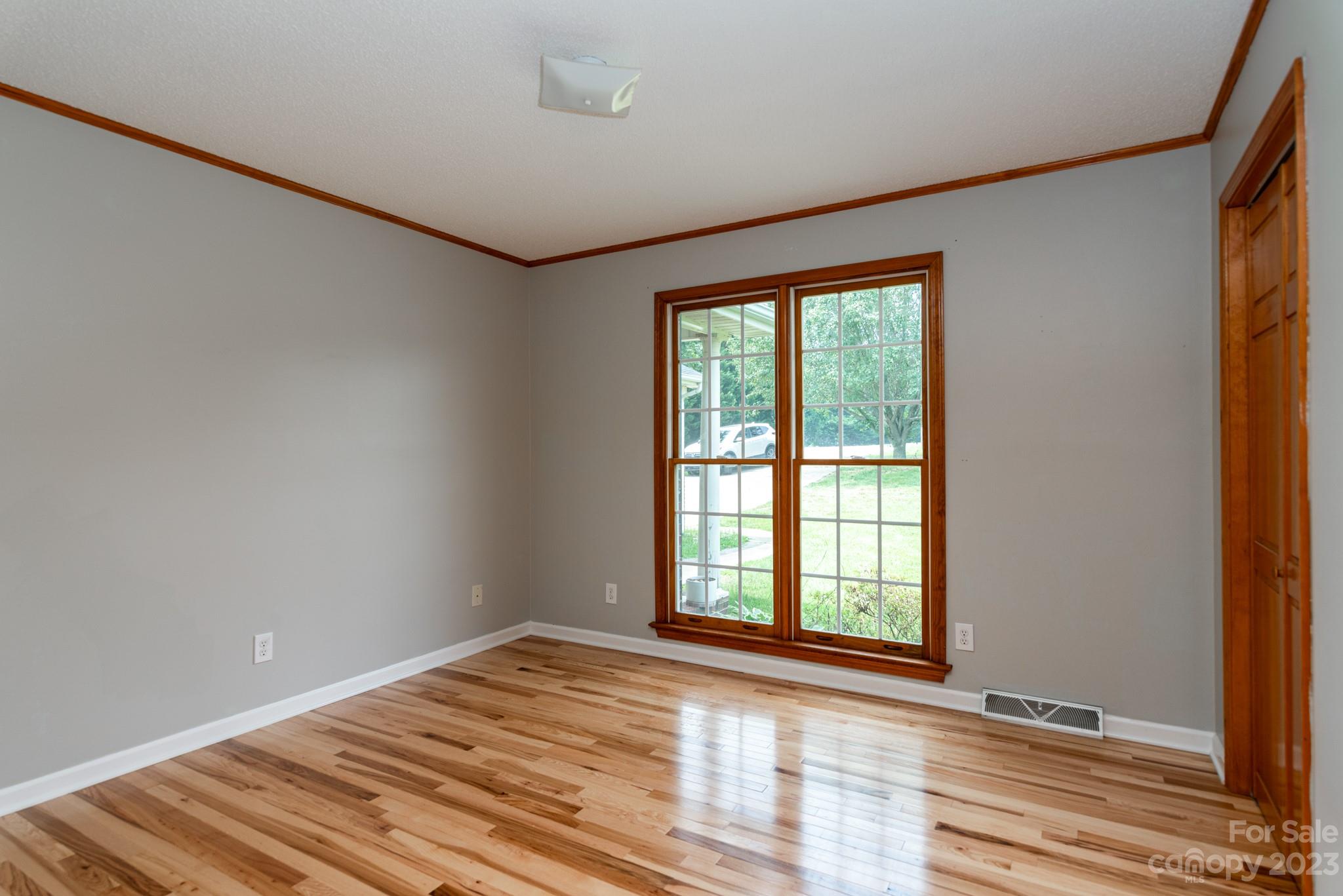 920 Bethel Church Road Lincolnton, NC 28092 - Photo 17 of 27 a view of an empty room with wooden floor and a window