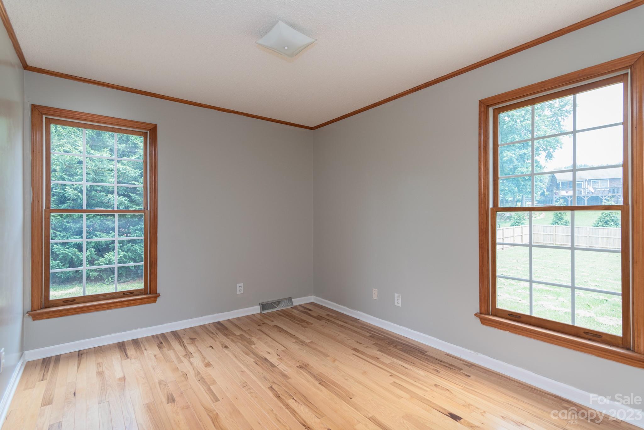 920 Bethel Church Road Lincolnton, NC 28092 - Photo 21 of 27 an empty room with wooden floor and windows