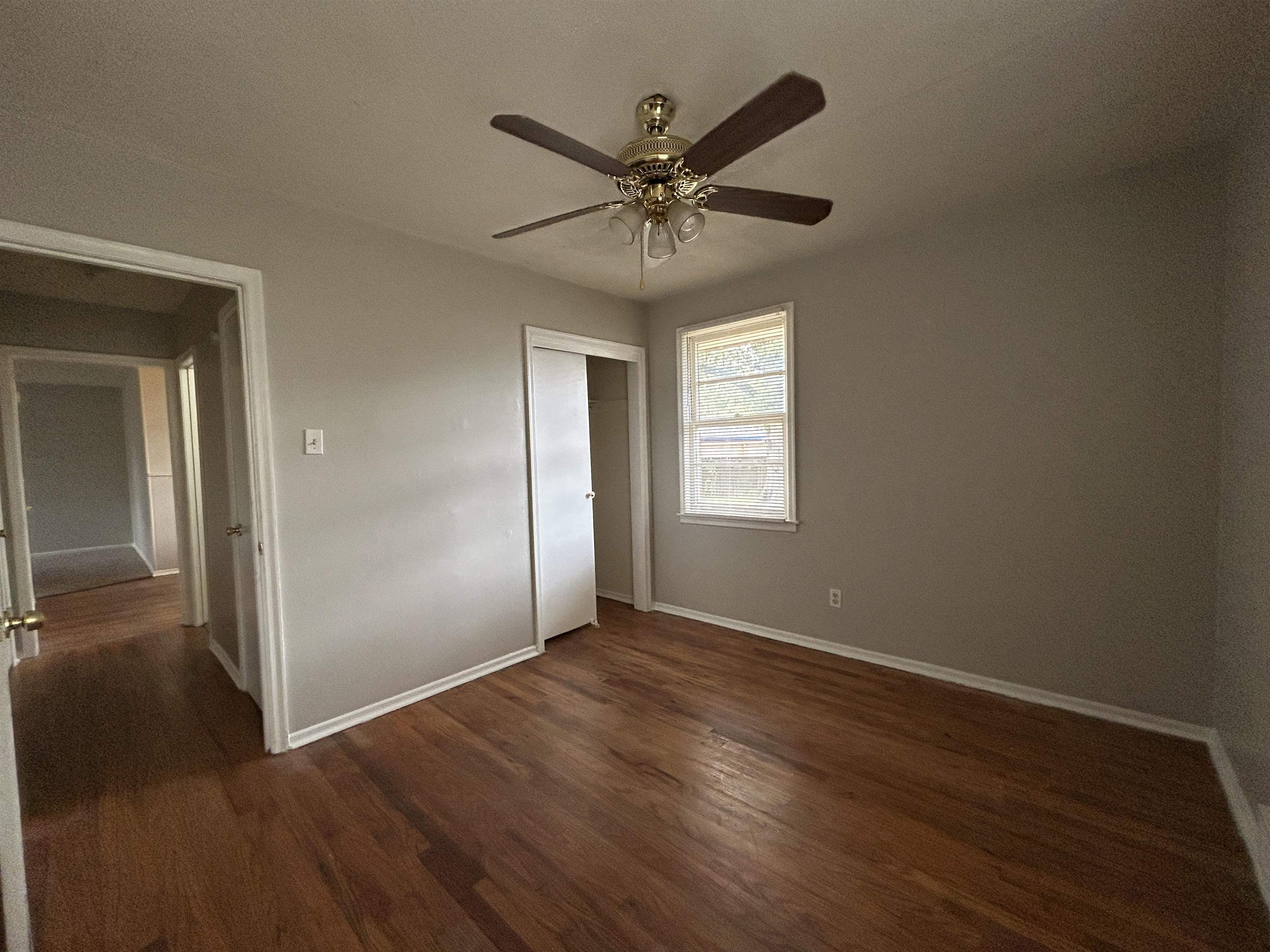 1809 Cherry Road Memphis, TN 38111 - Photo 11 of 16 an empty room with wooden floor closet and windows