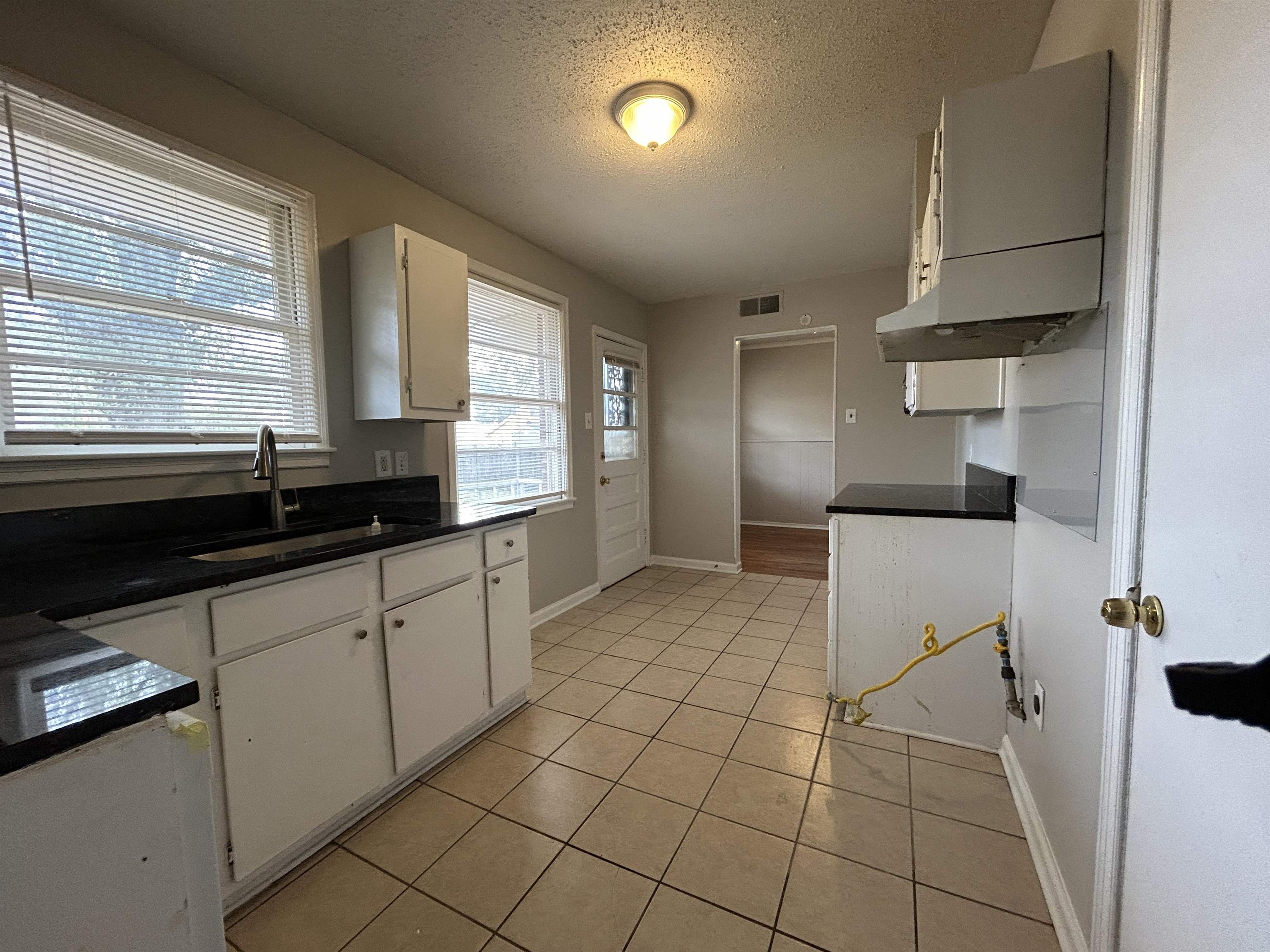 1809 Cherry Road Memphis, TN 38111 - Photo 6 of 16 a kitchen with stainless steel appliances a sink a stove a refrigerator a counter top space and cabinets