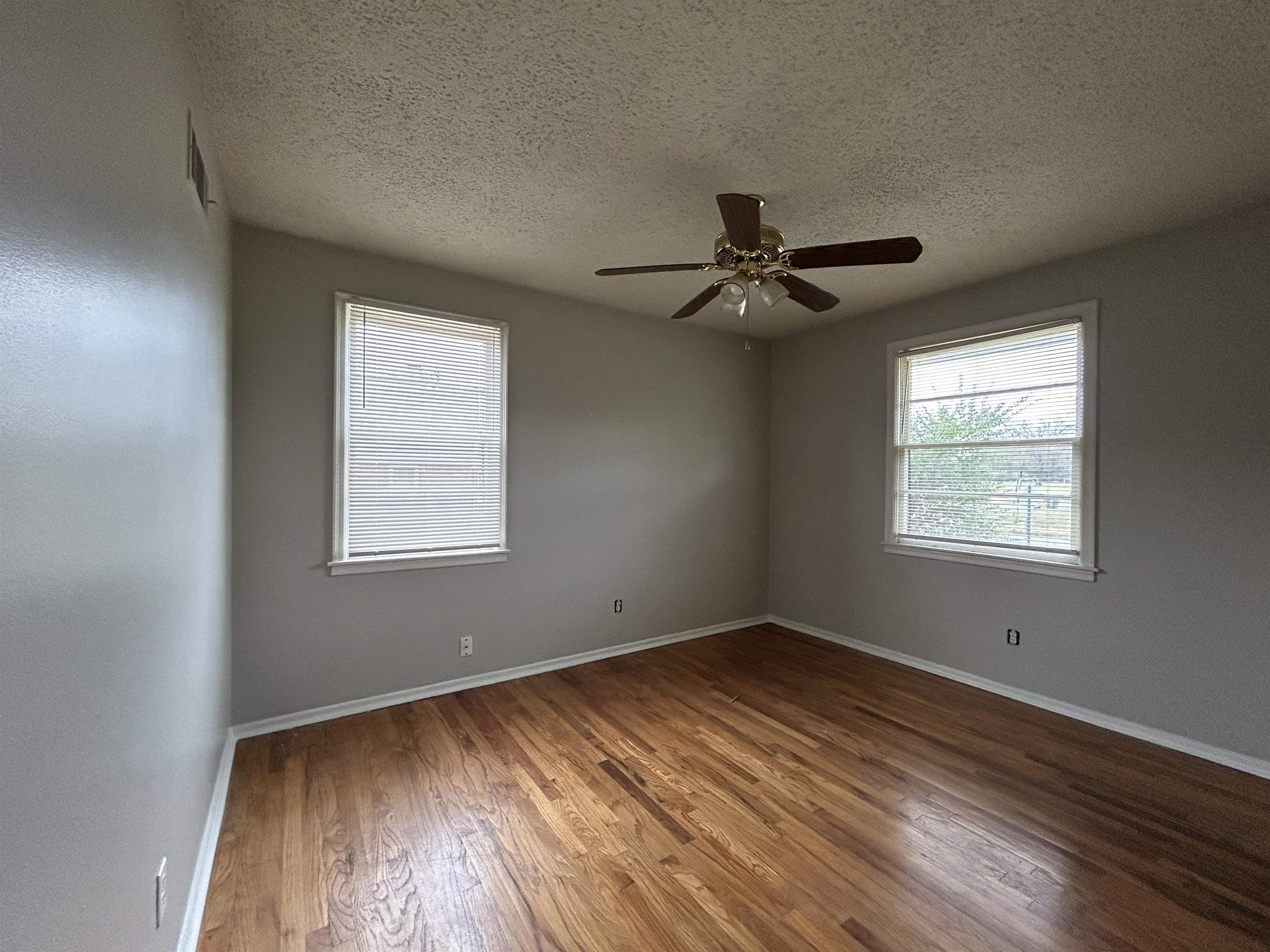 1809 Cherry Road Memphis, TN 38111 - Photo 8 of 16 a view of empty room with wooden floor and fan